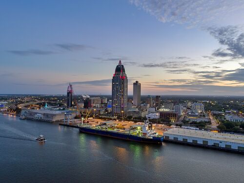 Drone shot of the Downtown Mobile, Alabama skyline at sunset
