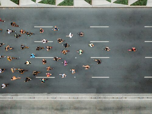 Aerial view of marathon city runners. One person leading marathon.