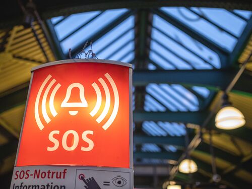 Illuminated SOS sign on a subway station.