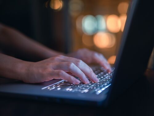 Close up of woman's hand typing on computer keyboard in the dark, working late on laptop at home.

Used for: Artificial Intelligence and the Future of Work
2025 Consensus Study Cover