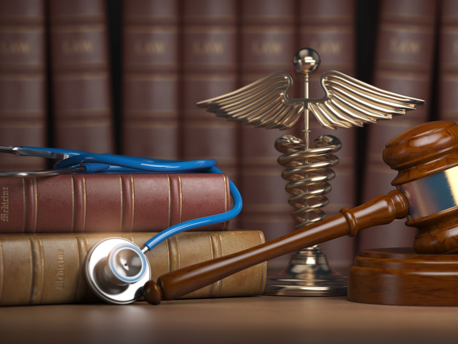 A gavel, a stethoscope and books on a table.