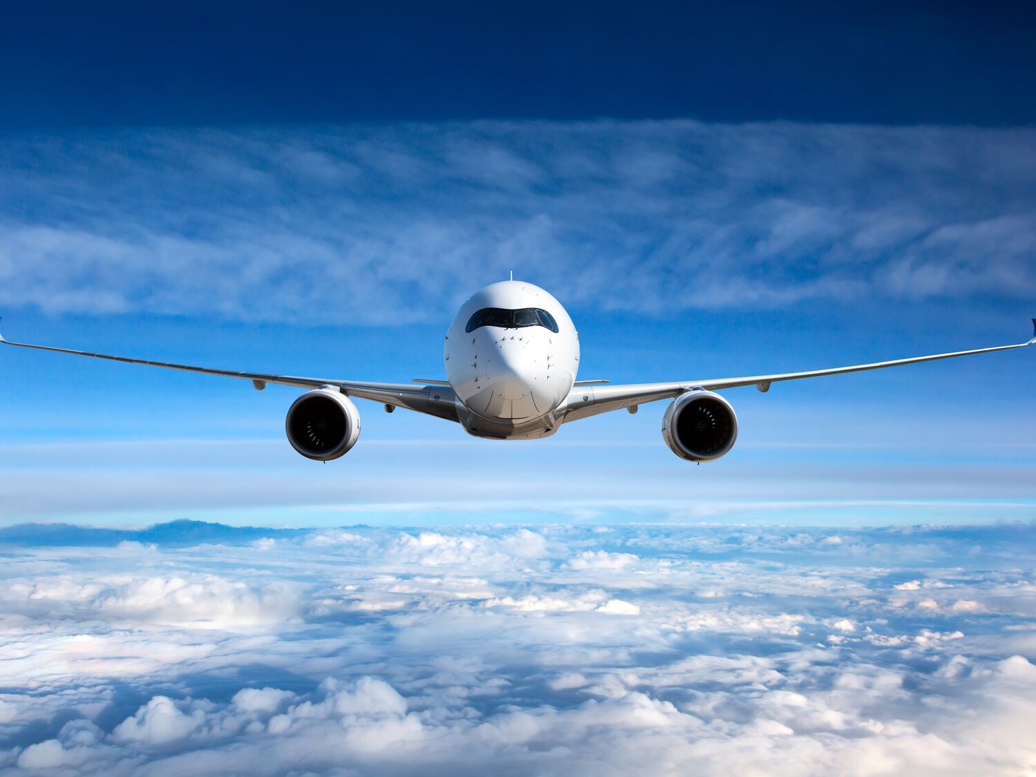 White passenger airplane in the sky.