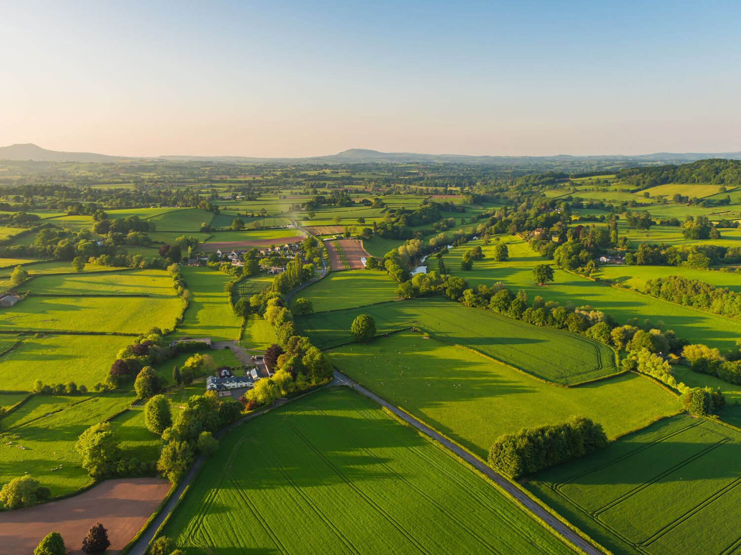 Aerial photograph rural landscape farms villages picturesque green patchwork pasture