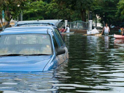 Car half submerged in a flooded town