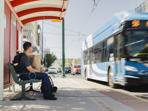 Man Waiting For Bus at the Bus Stop