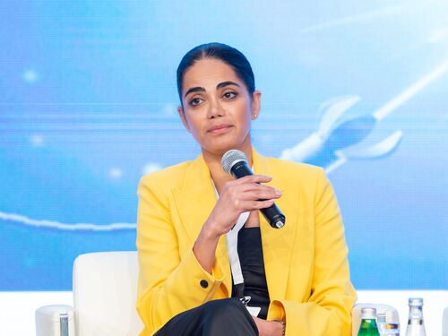 Kiana Aran sitting and holding a microphone at the Science and Entertainment Retreat.