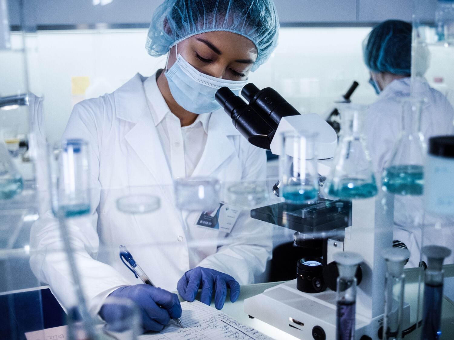 Scientists examines DNA models in modern Genetic Research Laboratory.