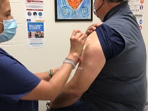 A nurse administers a COVID-19 vaccine to a GISD staff member.