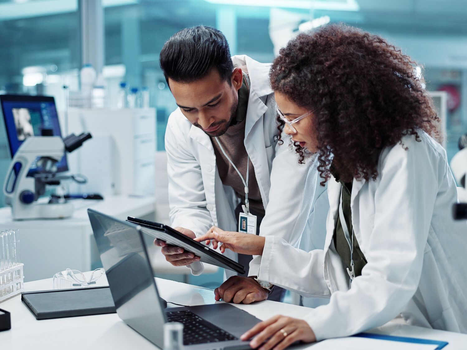 Two scientists collaborate on scientific research in a laboratory setting.