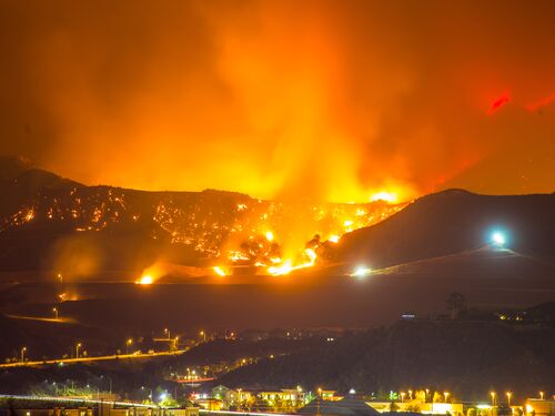 Night long exposure photograph of the Santa Clarita wildfire in CA. The Santa Clarita Valley mountains has drawn firefighters and emergency crews in the hills toward Acton. So far, the fire has burned 38,346 acres.