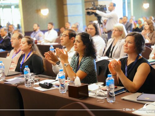 Group of people clapping during an event meeting.