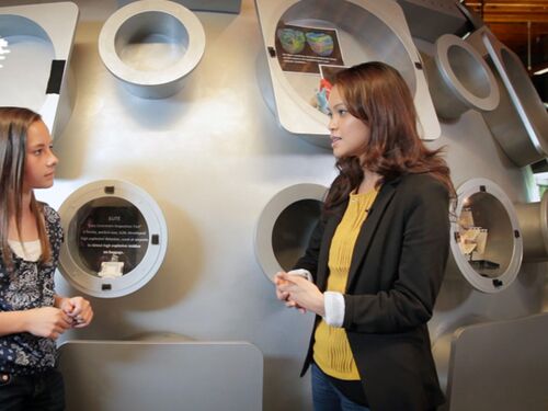 Two young girls having a conversation with each other.