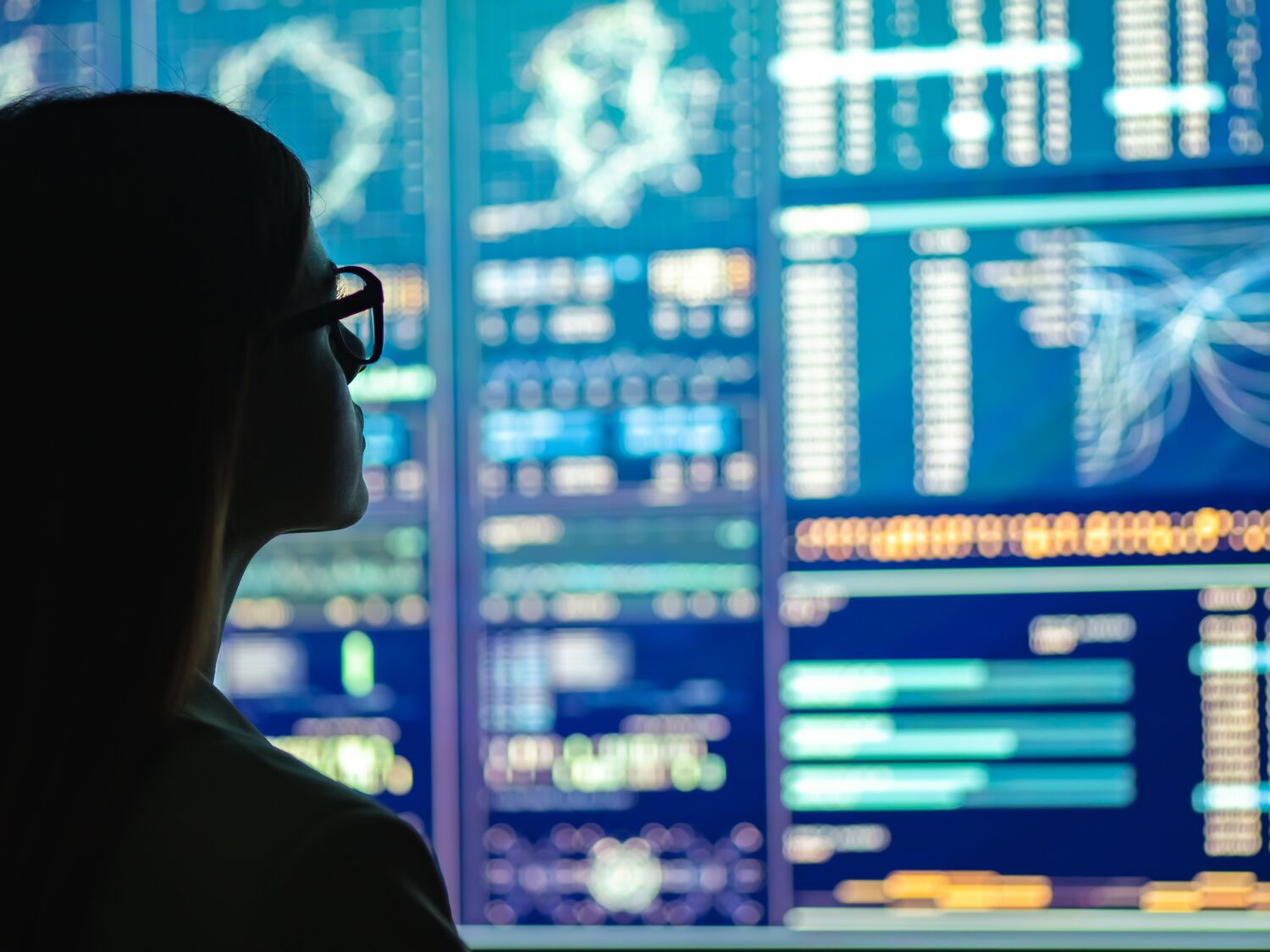 The businesswoman in glasses standing near the display
