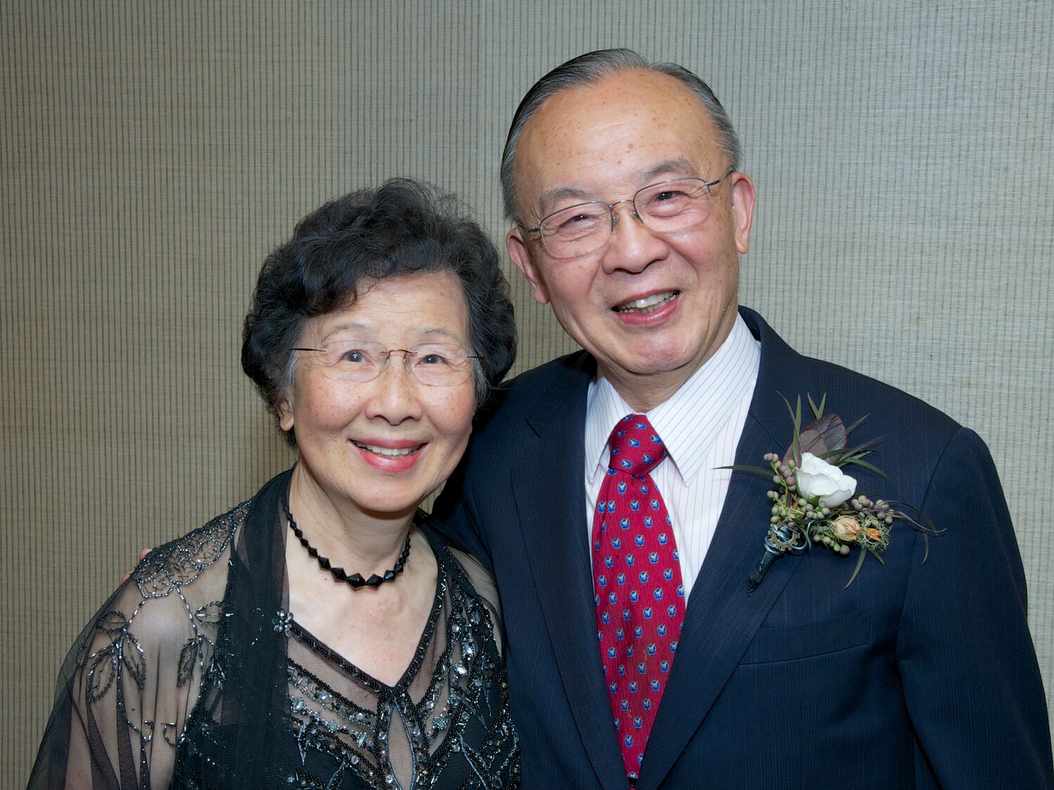 Kuang-Chung and Shu Chien side by side. Kuang-Chung has a black sequin dress and Shu wears a navy suit with red tie.