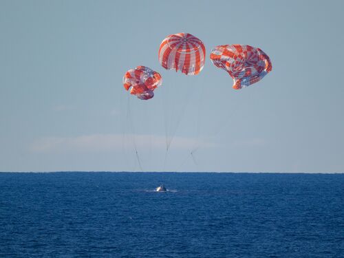 NASA’s Orion spacecraft with Artemis II crewmembers NASA astronauts Reid Wiseman, commander; Victor Glover, pilot; Christina Koch, mission specialist; and CSA (Canadian Space Agency) astronaut Jeremy Hansen, mission specialist aboard is seen as it lands in the Pacific Ocean off the coast of California, Friday, April 10, 2026. NASA’s Artemis II mission took Wiseman, Glover, Koch, and Hansen on a nearly 10-day journey around the Moon and back to Earth. Following a splashdown at 8:07p.m. EDT, NASA, U.S. Navy, and U.S. Air Force teams are working to bring the crewmembers and Orion spacecraft aboard USS John P. Murtha.  Photo Credit: (NASA/Bill Ingalls)