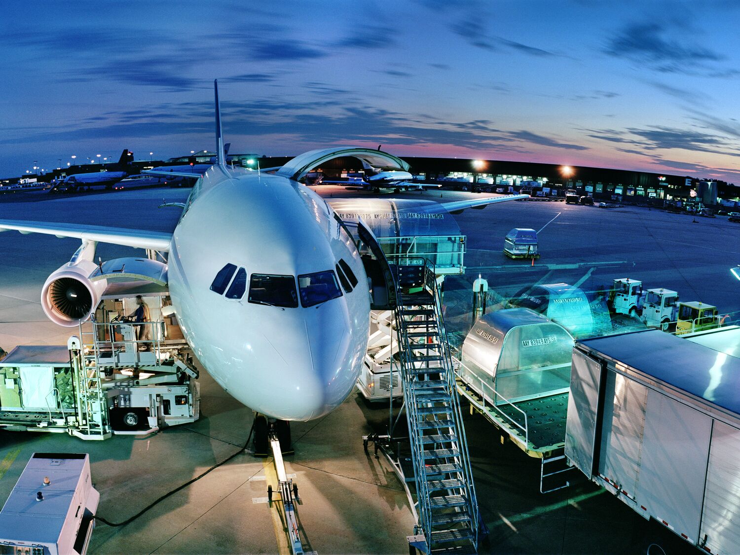 Cargo plane being loaded at night, elevated view