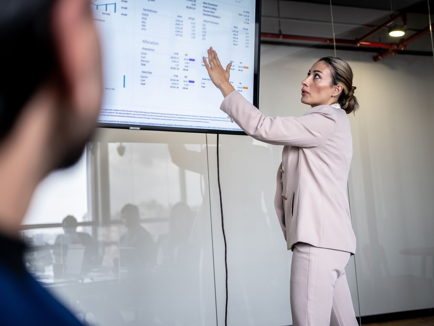 Mature businesswoman making a presentation to her coworkers in the meeting room