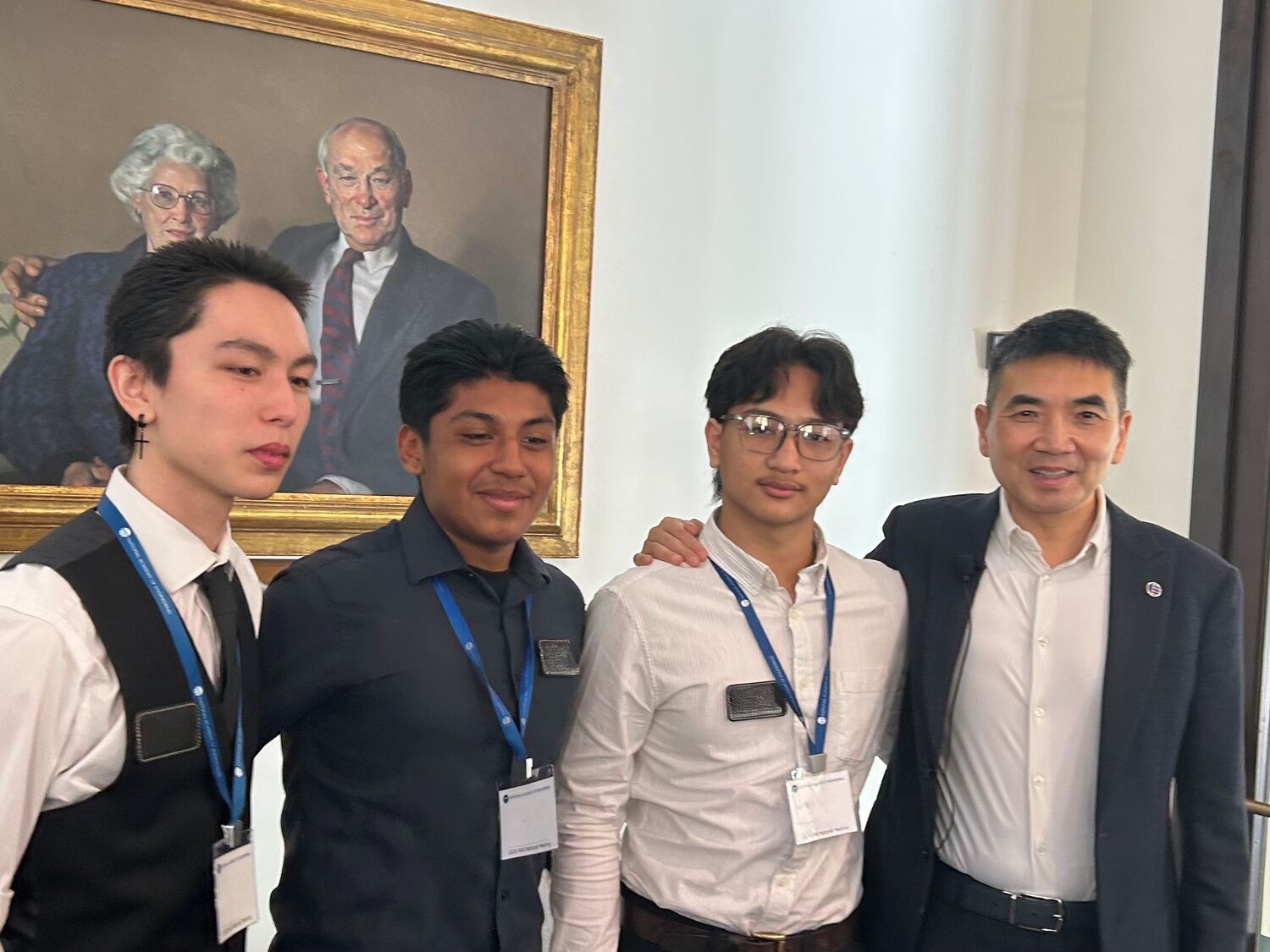 Eric Yuan standing next to 3 students.