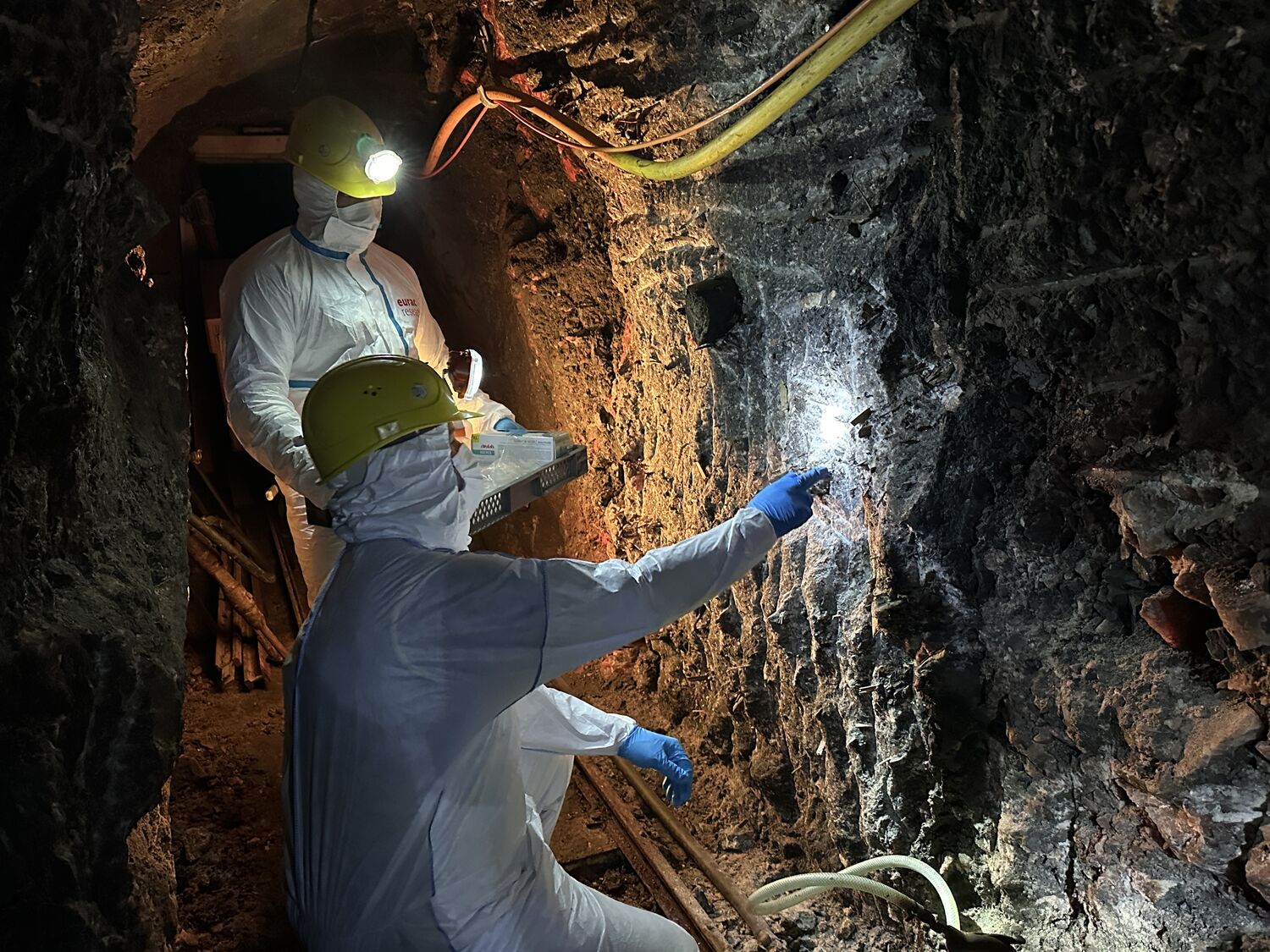 Frank Maixner and Mohamed Sabry Sarhan of the Institute for Mummy Studies examine paleofeces in a wall of the Hallstatt salt mine; photo by Nicola Twilley