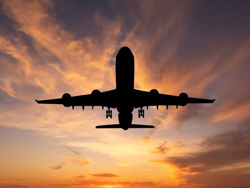 Airplane silhouette at sunset.