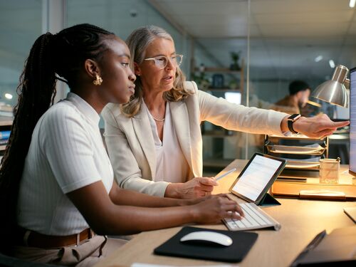 Business, people and computer with training in office to prepare accounting reports and finance filing system. Mentor, mature manager and helping intern accountant to track financial payments at desk