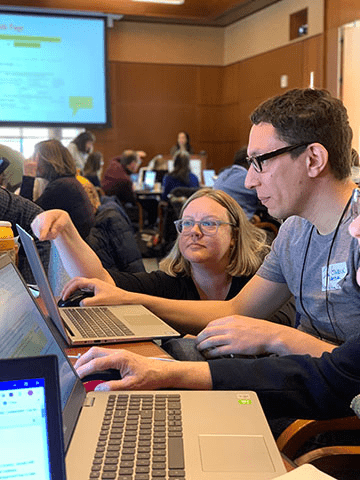 Phoebe Ayers assists a volunteer at the edit-a-thon
