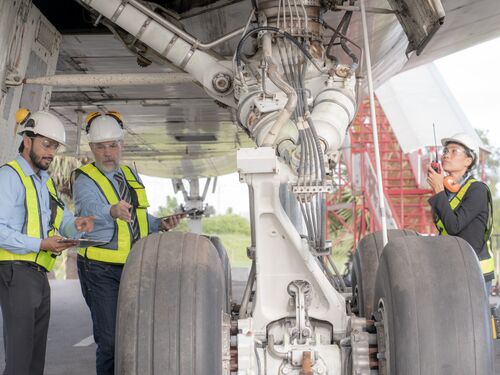 Engineers repairing and maintaining  on jet engine airplane .