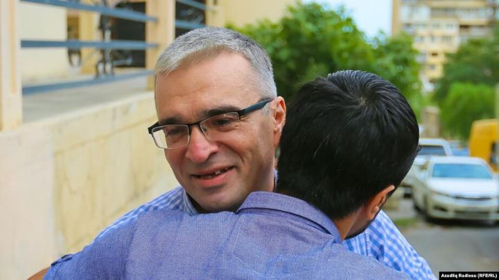 Ilgar hugging someone outside.