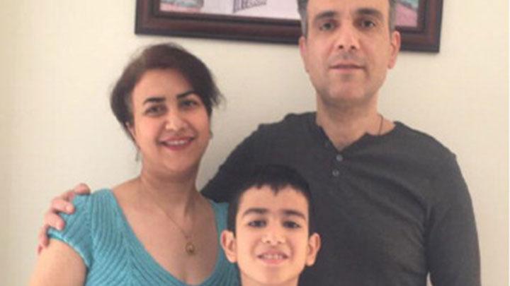 Payman posing with his wife and son.